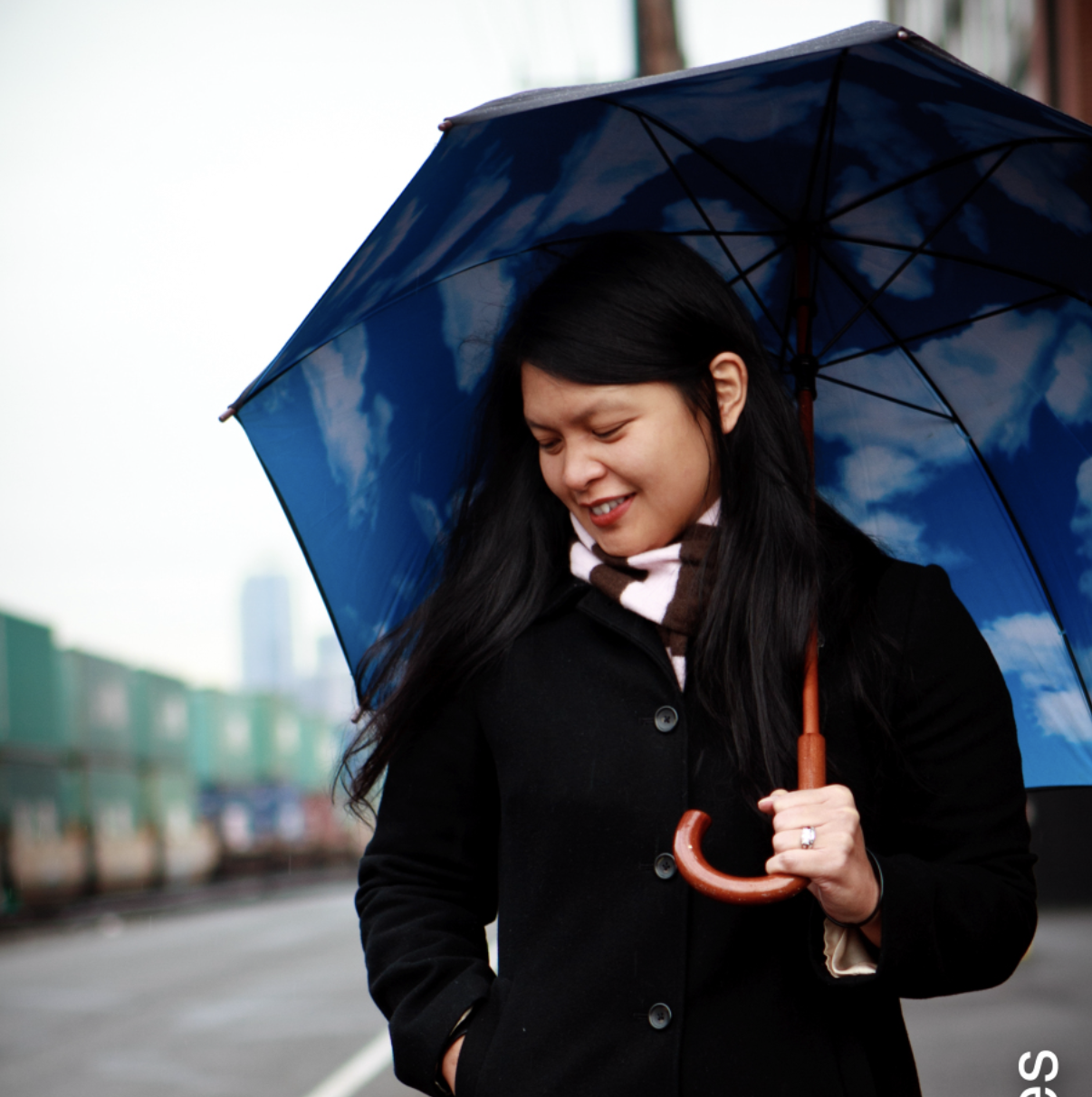 Portrait of Catherine Realce, founder of Love & Letterpress, holding an umbrella.